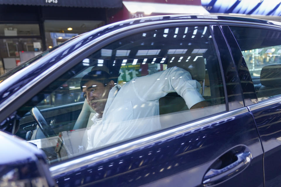 Driver Carlos Huerta, originally from Puebla, Mexico, gets ready for a pick-up in the Queens borough of New York, Thursday, Oct. 6, 2022. Huerta has been living apart from his wife and kids for nearly 20 years, picking up jobs from dish-washing to driving executives. He said he sends about $200 a week to his wife and mother in Mexico. (AP Photo/Seth Wenig)