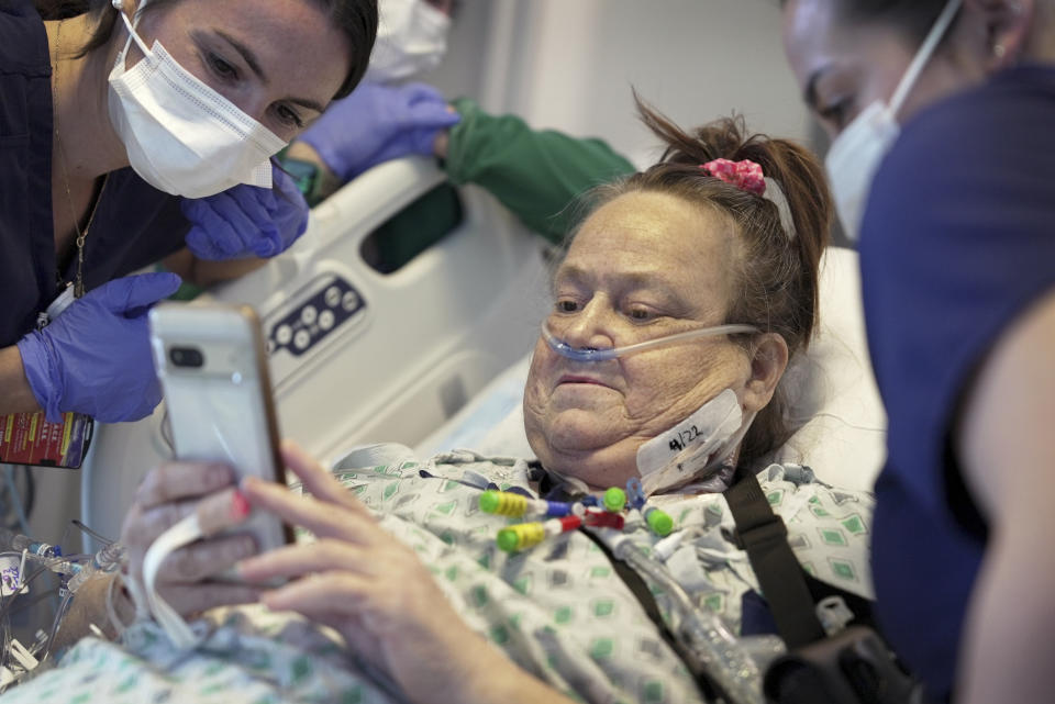 Lisa Pisano looks at photos of her dog after receiving a pig kidney transplant, at NYU Langone Health in New York, April 22, 2024. Doctors have transplanted a pig kidney into the New Jersey woman who was near death, part of a dramatic pair of surgeries that also stabilized her failing heart. (AP Photo/Shelby Lum)