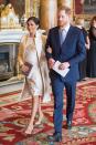 <p>To mark Charles’ 50th anniversary as the Prince of Wales, Meghan donned her Amanda Wakeley ‘Crombie’ coat with a floral brocade dress, her Wilbur and Gussie Oyster Clutch and her Paul Andrews pumps. <em>[Photo: Getty]</em> </p>