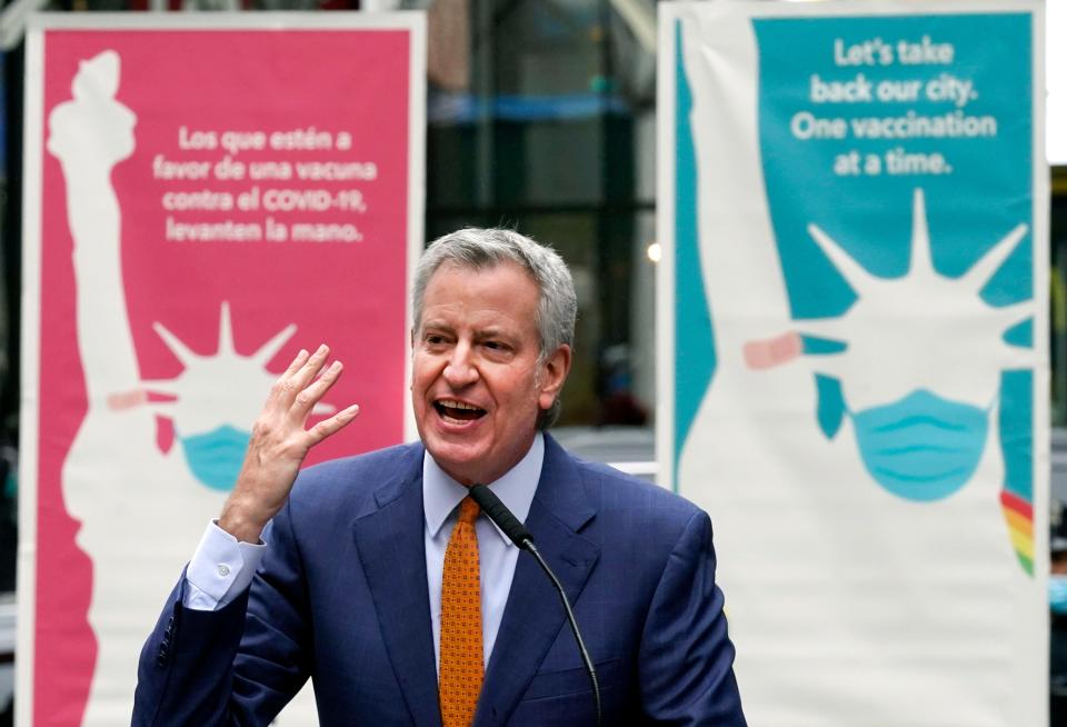 In this Monday, April 12, 2021 file photo, New York Mayor Bill de Blasio delivers remarks in Times Square after he toured the grand opening of a Broadway COVID-19 vaccination site intended to jump-start the city's entertainment industry, in New York. Blasio expects the city to “fully reopen” by July 1, with the lifting of the city’s COVID-19 restrictions.