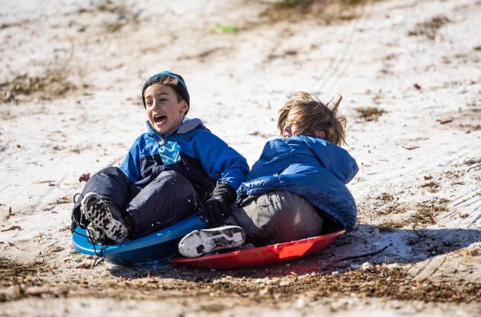 Children collide while sledding in Charlotte, N.C., on Saturday, January 22, 2022. Will we see snow this winter? Prospects are dicey, meteorologists say.