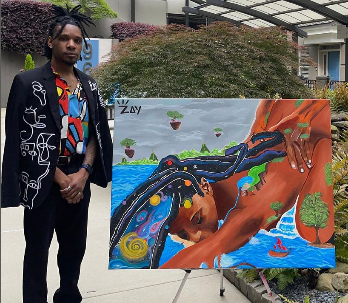 Rock Island artist Zay Williams and one of his paintings.