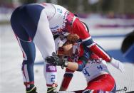 First placed Norway's Marit Bjoergen (L) celebrates with her team mate third placed Heidi Weng after finishing in the women's skiathlon event at the Sochi 2014 Winter Olympics in Rosa Khutor February 8, 2014. REUTERS/Carlos Barria