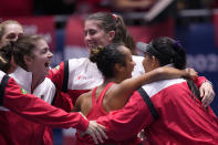 Canada's Leylah Fernandez celebrates with team members after wining against Italy's Jasmine Paolini, during their final singles tennis match at the Billie Jean King Cup finals at La Cartuja stadium in Seville, southern Spain, Spain, Sunday, Nov. 12, 2023. (AP Photo/Manu Fernandez)