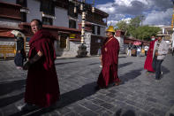 Monks circumambulate around the Jokhang Temple in Lhasa in western China's Tibet Autonomous Region, Tuesday, June 1, 2021, as seen during a government organized visit for foreign journalists. High-pressure tactics employed by China's ruling Communist Party appear to be finding success in separating Tibetans from their traditional Buddhist culture and the influence of the Dalai Lama. (AP Photo/Mark Schiefelbein)