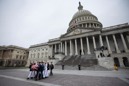 Joint service members of a military casket team carry the casket of Senator John McCain from the U.S. Capitol to a motorcade that will ferry him to a funeral service at the National Cathedral in Washington, U.S., September 1 2018. Jim Lo Scalzo/Pool via REUTERS