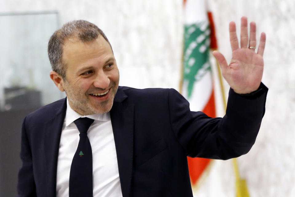 FILE - This Feb. 2, 2019 file photo, Lebanese Foreign Minister Gebran Bassil arrives to attend the first meeting of the Lebanese cabinet at the Presidential Palace in Baabda, east of Beirut, Lebanon. Lebanese are campaigning against the participation of their acting foreign minister in the prestigious World Economic Forum in Davos, saying Bassil, who was the target of popular anger in the ongoing nationwide protests, should not represent them on the international stage. (AP Photo/Bilal Hussein, File)