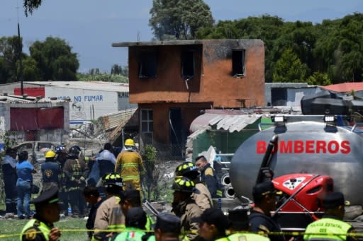 Firefighters work at the site after a series of explosions at fireworks warehouses in Tultepec, central Mexico, on July 5, 2018