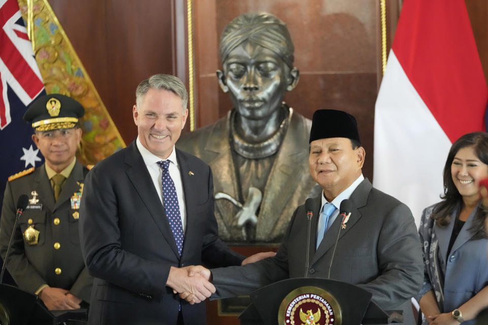 Indonesian Defense Minister Prabowo Subianto, right, shakes hands with Australian Deputy Prime Minister and Defense Minister Richard Marles following their meeting in Jakarta, Indonesia, Friday, Feb. 23, 2024. (AP Photo/Achmad Ibrahim)