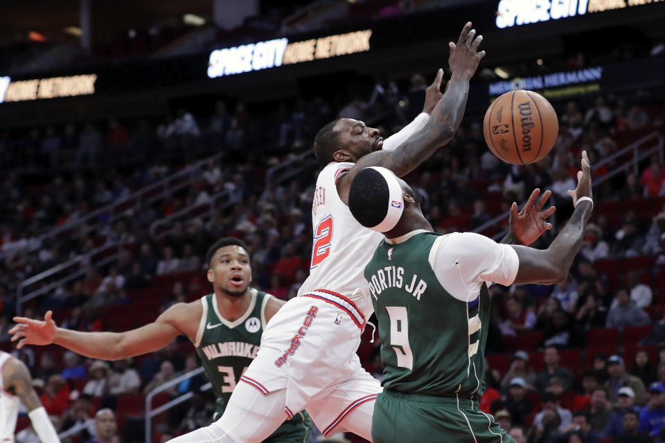 Houston Rockets forward Jeff Green, center, loses the ball on a drive to the basket between Milwaukee Bucks forwards Giannis Antetokounmpo, left, and Bobby Portis Jr. (9) during the first half of an NBA basketball game Saturday, Jan. 6, 2024, in Houston. (AP Photo/Michael Wyke)