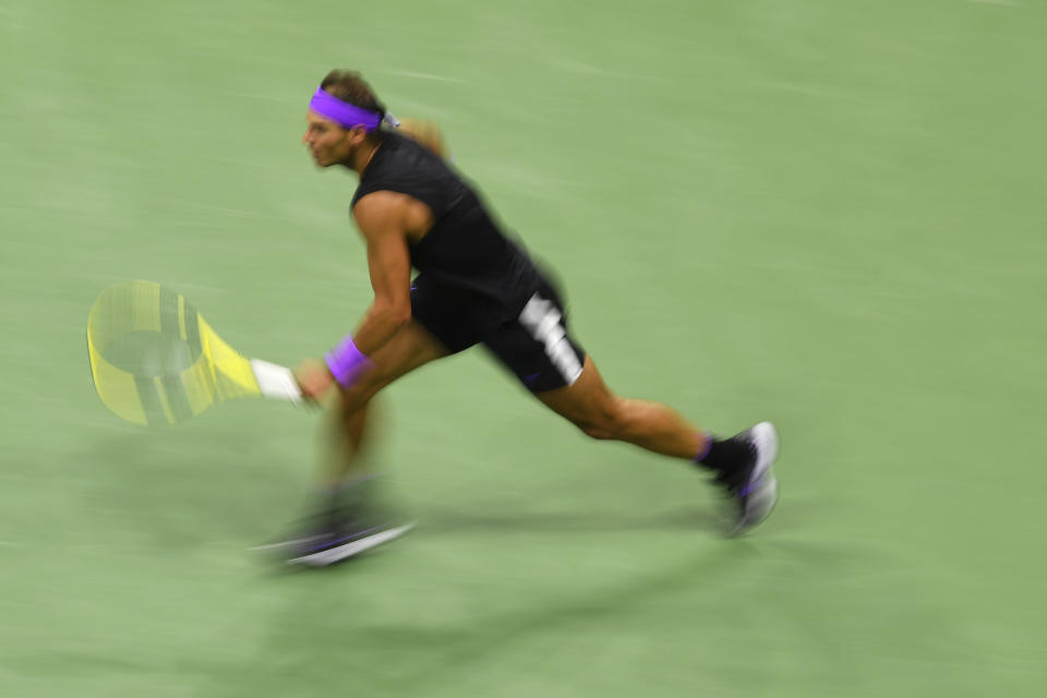 Rafael Nadal, of Spain, chases down a shot from Matteo Berrettini, of Italy, during the men's singles semifinals of the U.S. Open tennis championships Friday, Sept. 6, 2019, in New York. (AP Photo/Sarah Stier)