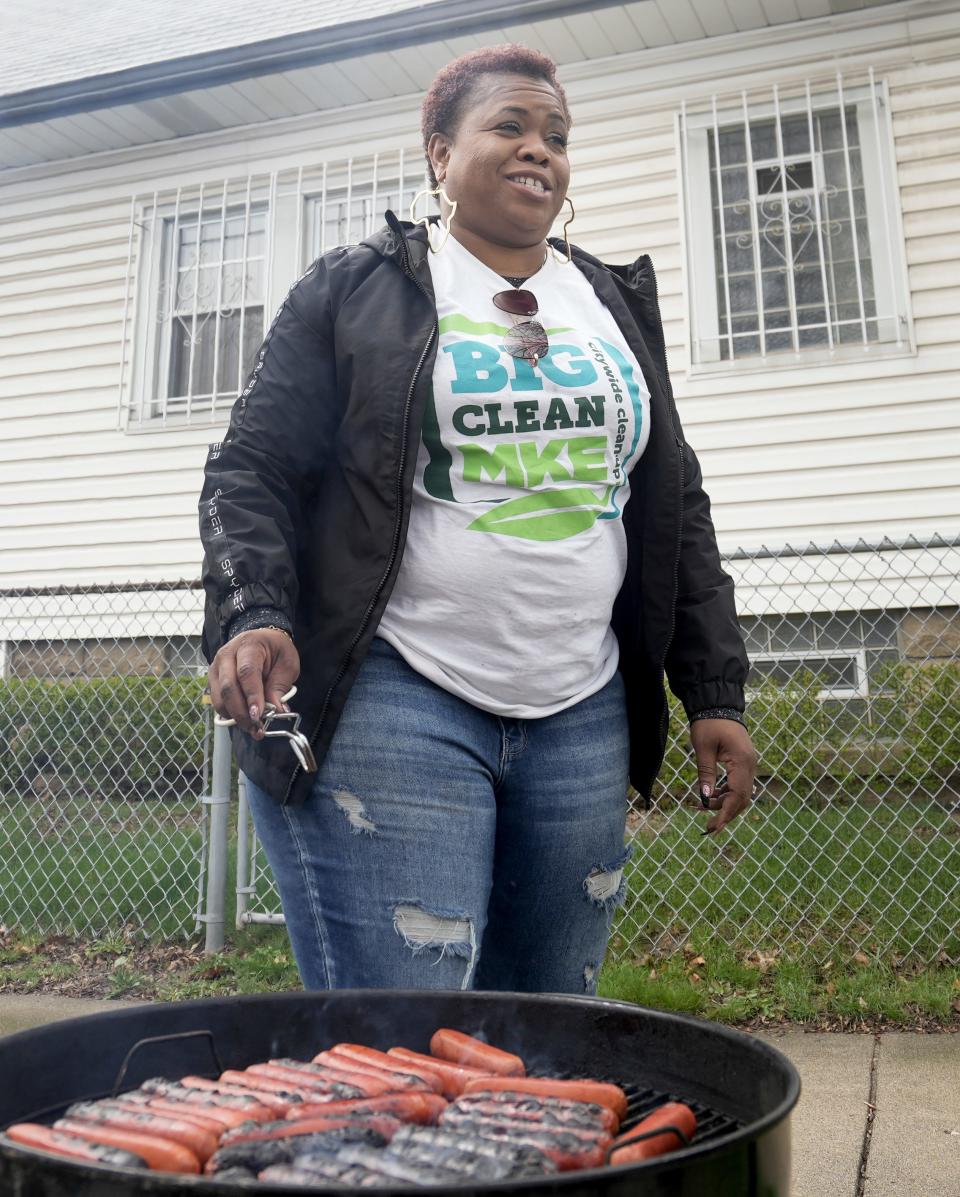 Adrian Spencer puts some hotdogs on the grill during the clean up hosted by United Methodist ChildrenÕs Services of Wisconsin, Inc., April 22.