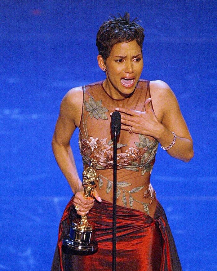 Halle Berry crying while holding her Oscar on stage