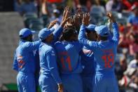 India's cricket team celebrate after West Indies batsman Dwayne Smith (not pictured) was caught out by wicket keeper MS Dhoni (2nd R) during their Cricket World Cup match in Perth, March 6, 2015. REUTERS/David Gray