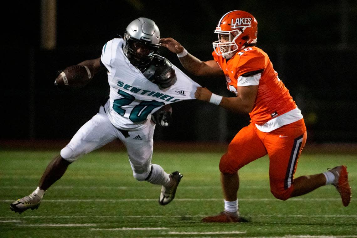 Lakes’ Chris Macon tackles Spanaway Lake running back D’Aryhian Clemons during the second quarter of a 3A PCL game on Monday, Oct. 17, 2022, at Harry E. Lang Stadium in Lakewood, Wash.