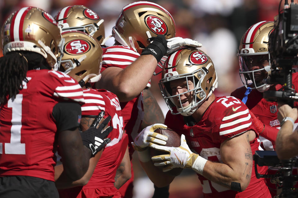 Christian McCaffrey celebrates with his teammates after a record-tying touchdown Sunday. (AP Photo/Jed Jacobsohn)