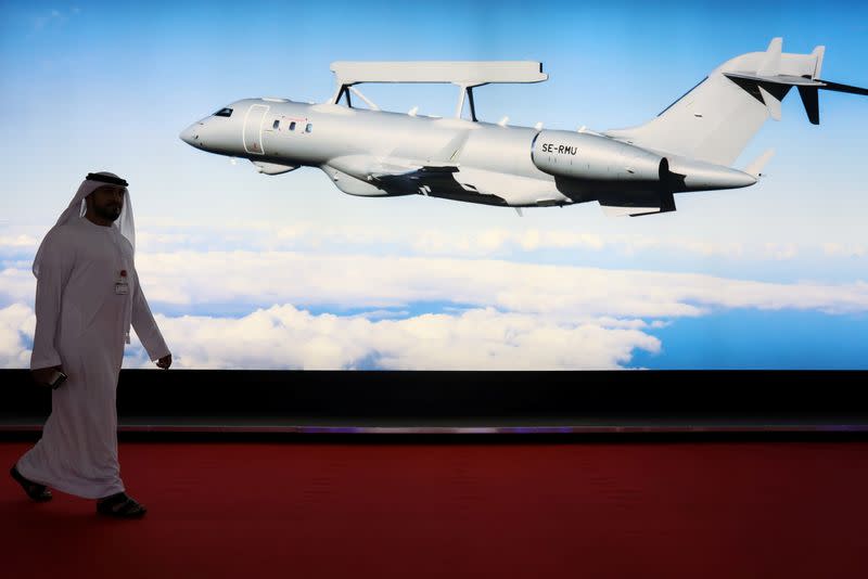 FILE PHOTO: A visitor walks past the Saab Technologies display, featuring the GlobalEye aircraft, during the fifth day of Dubai Air Show in Dubai