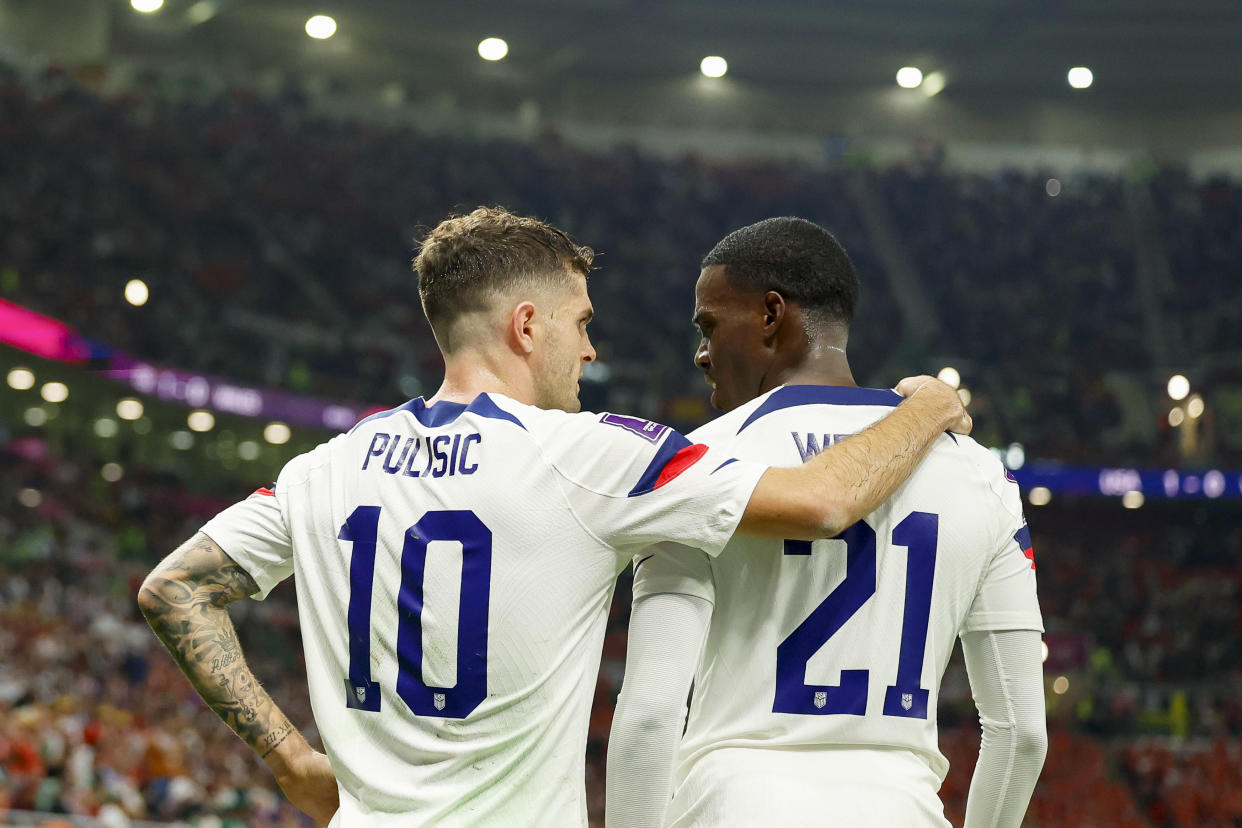 DOHA, QATAR - NOVEMBER 21: Christian Pulisic of USA and Timothy Weah of USA speaks with during the FIFA World Cup Qatar 2022 Group B match between USA and Wales at Ahmad Bin Ali Stadium on November 21, 2022 in Doha, Qatar. (Photo by Berengui/DeFodi Images via Getty Images)