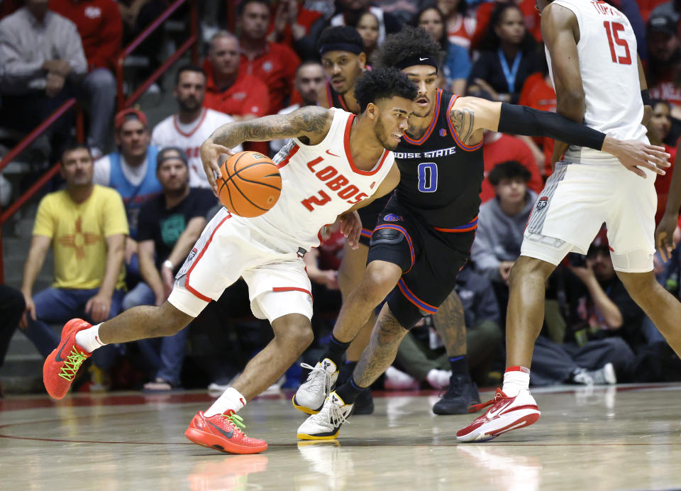 New Mexico guard Donovan Dent tries to dribble past Boise State guard Roddie Anderson III during the first half of an NCAA college basketball game, Wednesday, Jan. 31, 2024, in Albuquerque, N.M. (AP Photo/Eric Draper)