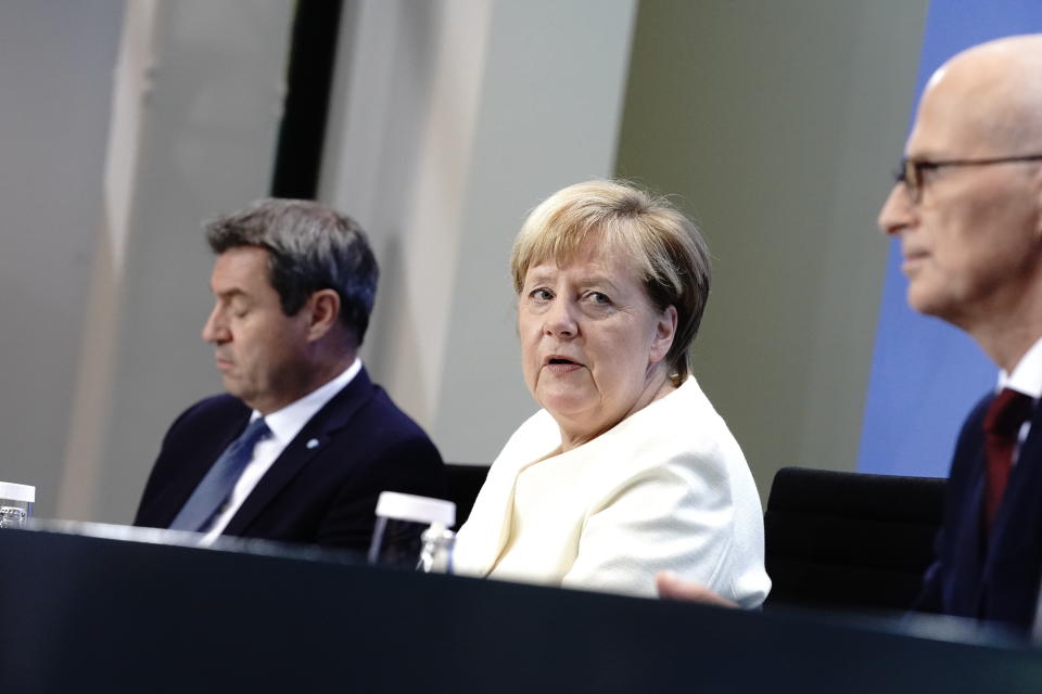 German Chancellor Angela Merkel, centre, Markus Soder, Prime Minister of Bavaria and CSU Chairman, left and Peter Tschentscher, the First Mayor of Hamburg, take part in a press conference, in Berlin, Tuesday, Sept. 29, 2020. Chancellor Angela Merkel and the governors of Germany’s 16 states conferred on how to prevent the country’s coronavirus infection figures from accelerating to the levels being seen in other European countries. (Kay Nietfeld/dpa via AP)