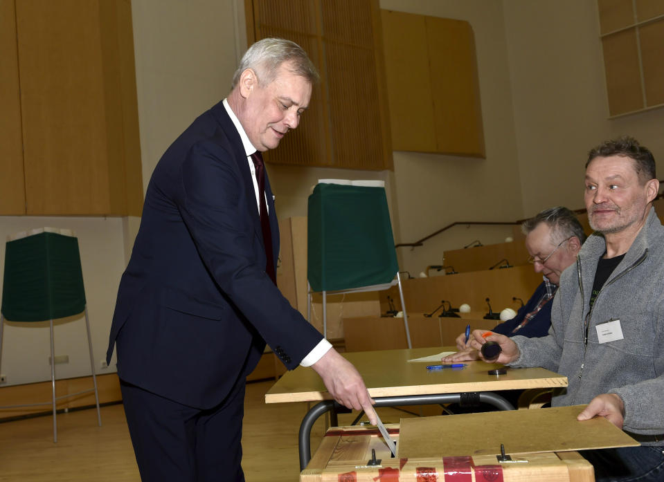 Electoral official observes as the Chairman of the Finnish Social Democratic Party and parliamentary candidate Antti Rinne cast his ballot in parliamentary elections, in M'nts'l', Finland on Sunday, April 14, 2019. Voters in Finland are casting ballots in a parliamentary election after fierce debates over how best to tackle climate change dominated the campaign. (Emmi Korhonen/Lehtikuva via AP)