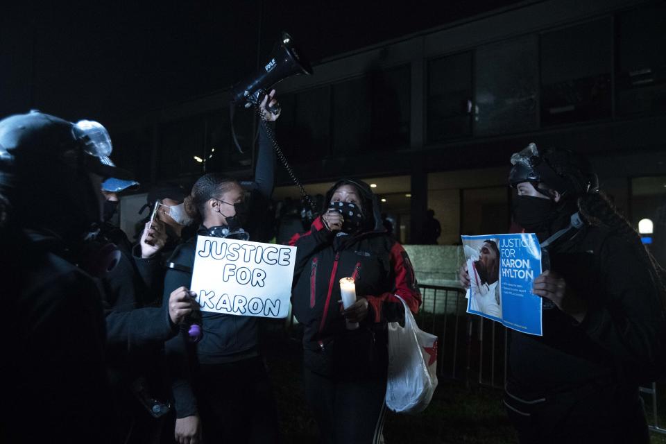 Demonstrators protest at the fourth district Washington police station in Washington, Wednesday, Oct. 28, 2020. Demonstrators gathered at the police station in protest over a fatal a crash involving a moped driver who died when he police were attempting to pull him over. The crash happened last Friday. (AP Photo/Jose Luis Magana)