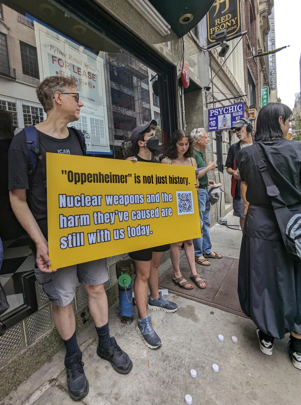 Activists hold a sign while rallying in New York City on July 15, 2023. The group gathered to bring attention to residents in New Mexico who were exposed to radiation during the Trinity atomic test done in 1945 as part of the Manhattan Project. The rally proceeded a screening and panel discussion on the new film "Oppenheimer." (Andrew Facini via AP)