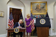 President Joe Biden signs into law S. 2938, the Bipartisan Safer Communities Act gun safety bill, in the Roosevelt Room of the White House in Washington, Saturday, June 25, 2022. First lady Jill Biden looks on at right. (AP Photo/Pablo Martinez Monsivais)