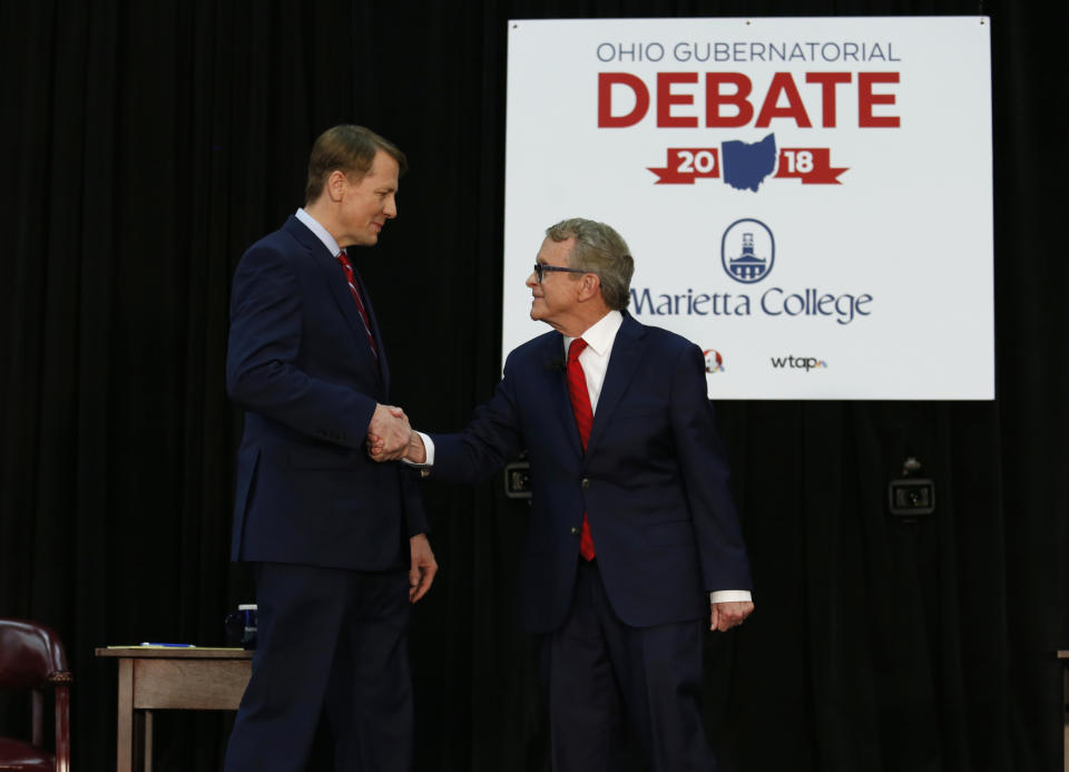 Democratic gubernatorial candidate Richard Cordray, left, and Ohio Attorney General and Republican gubernatorial candidate Mike DeWine shake hands before a debate at Marietta College in Marietta, Ohio, Monday, Oct. 1, 2018. (AP Photo/Paul Vernon, Pool)