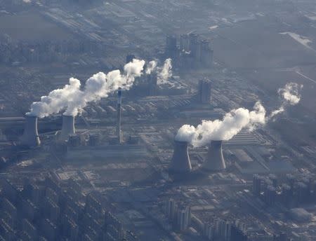 Chimneys of a power plant are pictured from a plane, on the outskirts of Beijing January 8, 2016. REUTERS/Kim Kyung-Hoon