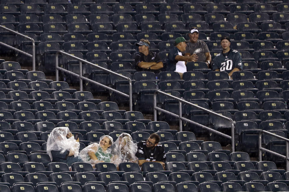 Fans sit in a rain storm as severe weather delays the start of an NFL football game between the Philadelphia Eagles and the Atlanta Falcons, Thursday, Sept. 6, 2018, in Philadelphia. (AP Photo/Matt Rourke)