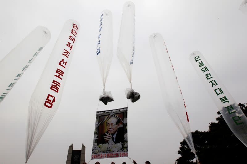 FILE PHOTO: A portrait of deceased North Korean defector Hwang is hung on balloons as former North Korean defectors prepare to release them towards the North in Paju