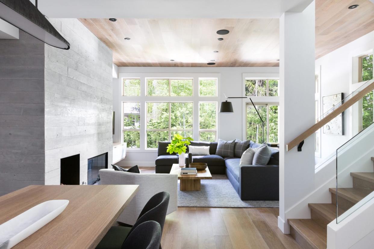 mountain living room with large windows and sleek gray sofas