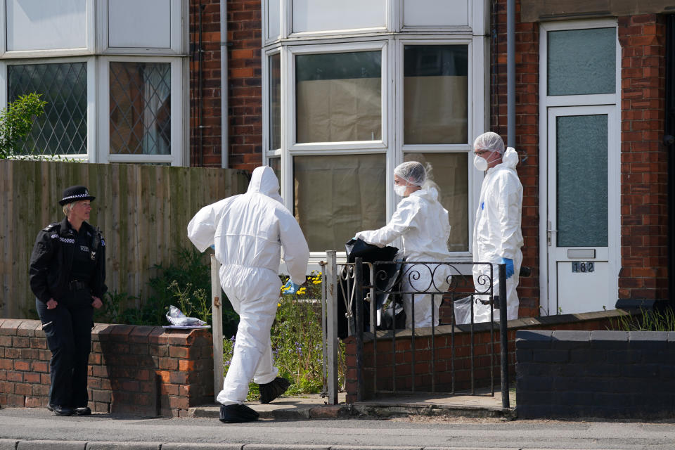 Police officers at the scene in High Holme Road, Louth, Lincolnshire, following the death of a woman and child on Monday. An urgent appeal has been issued by police to find Daniel Boulton, 29, in connection with the incident. Picture date: Tuesday June 1, 2021.