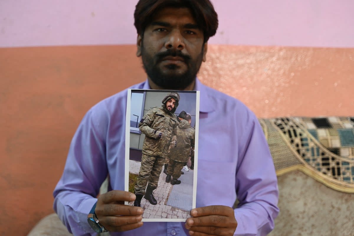 This photo taken on February 22, 2024 shows a picture printout of Indian national Mohammed Asfan, seen wearing Russian military fatigues, who last called family from the southern Russian city before being deployed amid the conflict in Ukraine  (AFP via Getty Images)