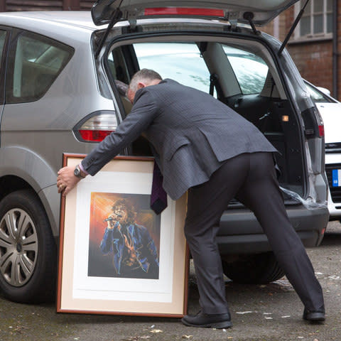 Some of the paintings are carried into Gloucester Crown Court - Credit: SWNS.com