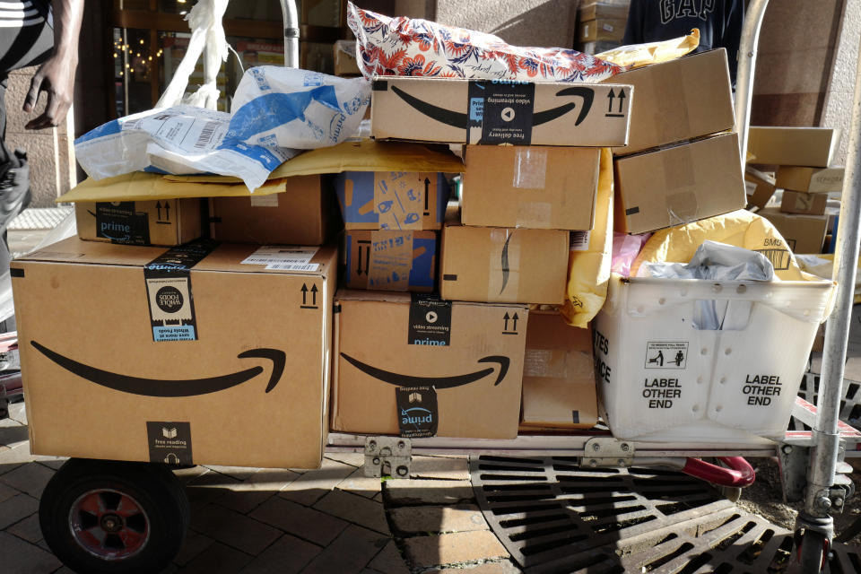 FILE - In this Oct. 10, 2018, file photo Amazon Prime boxes are loaded on a cart for delivery in New York. Amazon, which is racing to deliver packages faster, is turning to its employees with a proposition: Quit your job and we’ll help you start a business delivering Amazon package. The offer, announced Monday, May 13, 2019, comes as Amazon seeks to speed up its shipping time from two days to one for its Prime members. (AP Photo/Mark Lennihan, File)