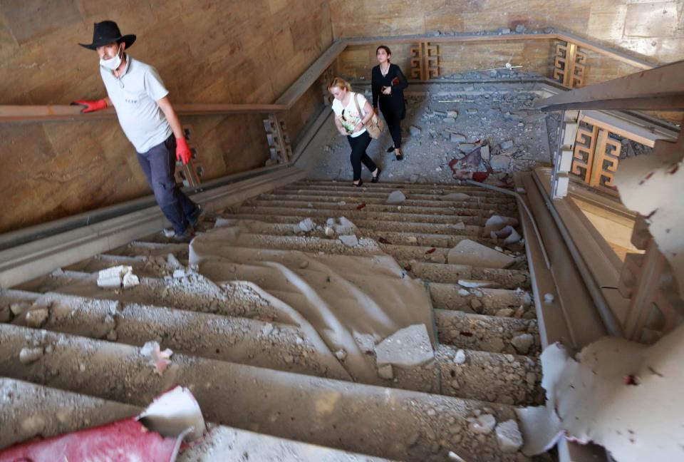 People walk through rubble after&nbsp;the Grand National Assembly of Turkey was bombed by rebel jets.&nbsp;