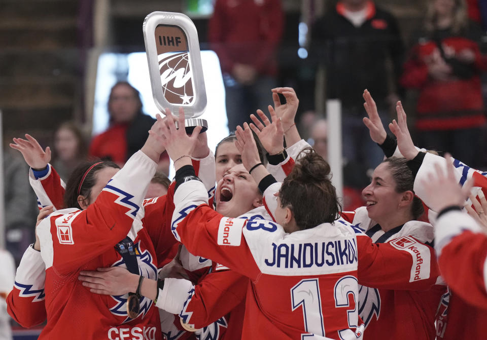 Czechia reacts with the bronze trophy after defeating Switzerland during the third period of the bronze medal IIHF Women's World Hockey championship game in Brampton, Ontario, on Sunday, April 16, 2023. (Nathan Denette/The Canadian Press via AP)