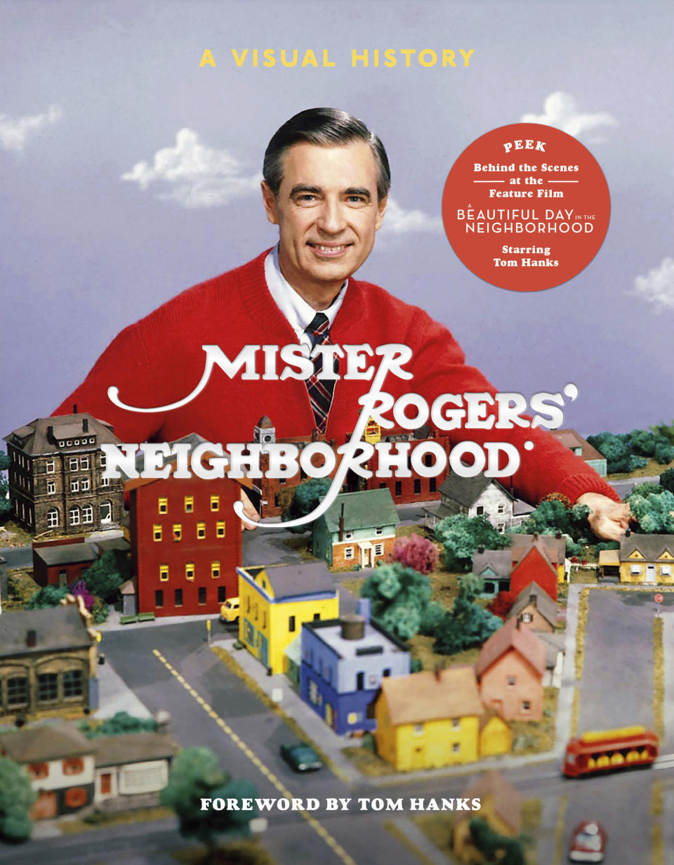 This cover image released by Clarkson Potter shows “Mister Rogers’ Neighborhood: A Visual History,” by Fred Rogers Productions, Tim Lybarger, Melissa Wagner and Jenna McGuigan. (Clarkson Potter via AP)
