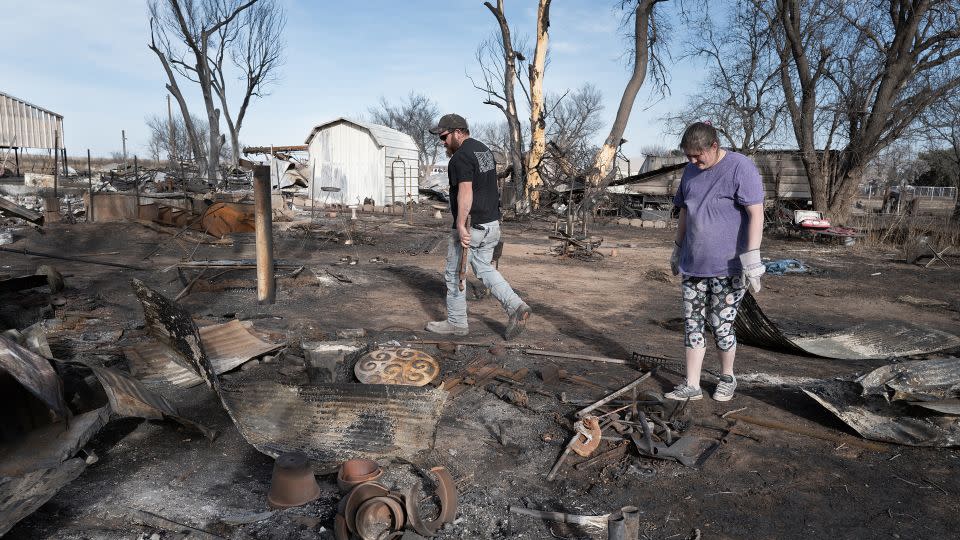Tia Champion and her husband Tim help a friend search the remains of her home near Stinnett, Texas, after it was destroyed by the Smokehouse Creek Fire. - Scott Olson/Getty Images