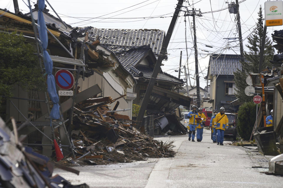 Police officers work in a quake-hit area in Suzu, Ishikawa prefecture, Japan Sunday, Jan. 7, 2024. A major earthquake slammed western Japan on Jan. 1, killing scores of people, toppling buildings and setting off landslides. (Kyodo News via AP)