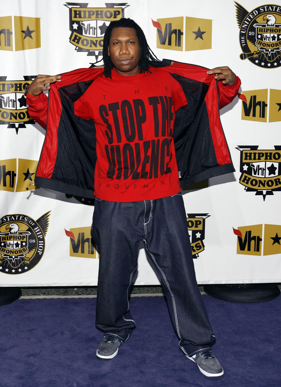 FILE - In this Thursday, Oct. 2, 2008 file photo, rapper KRS One shows his shirt which reads "STOP THE VIOLENCE" as he arrives at the VH1 Hip Hop Honors show in New York. KRS-One duplicated Malcolm X’s gun-in-the-window pose on the cover of his 1988 classic album, "By Any Means Necessary." (AP Photo/Jason DeCrow)