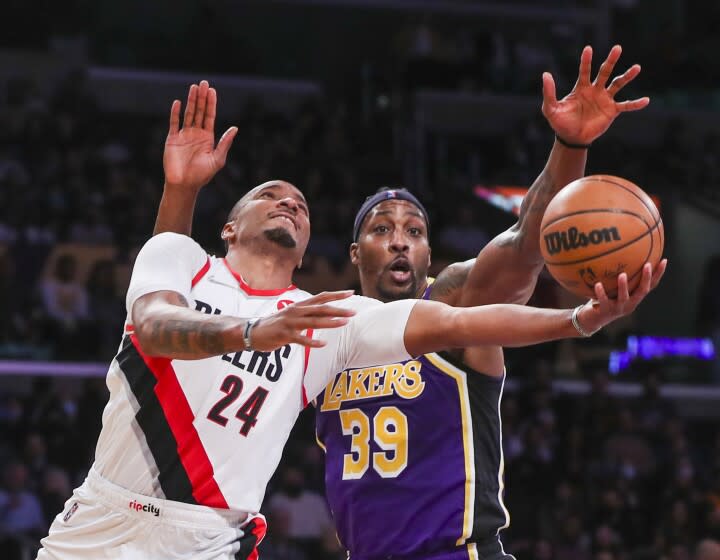 Los Angeles, CA - February 02: Los Angeles Lakers center Dwight Howard, right, battles Portland Trail Blazers forward Norman Powell as he goes up for a basket in the second half at Crypto.com Arena in Los Angeles Wednesday, Feb. 2, 2022. Lakers won 94-99. (Allen J. Schaben / Los Angeles Times)