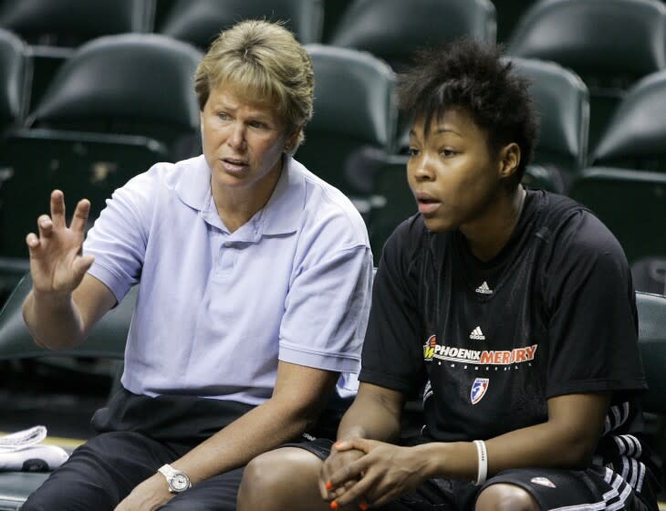 FILE - Phoenix Mercury general manager Ann Meyers Drysdale, left, talks with forward Cappie Pondexter.