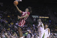 Oklahoma guard Otega Oweh (3) scores past Baylor forward Jonathan Tchamwa Tchatchoua (23) during the first half of an NCAA college basketball game Wednesday, Feb. 8, 2023, in Waco, Texas. (AP Photo/Rod Aydelotte)