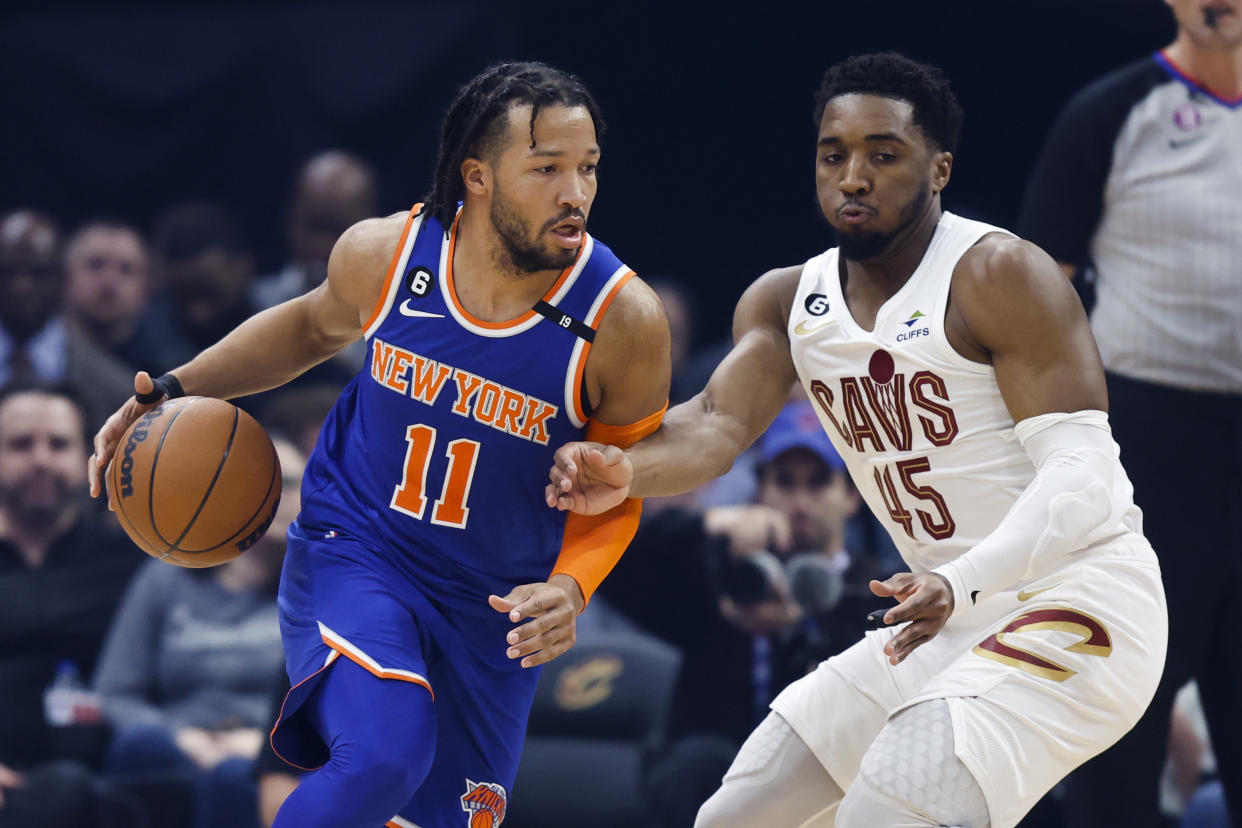 New York Knicks guard Jalen Brunson (11) drives against Cleveland Cavaliers guard Donovan Mitchell (45) during the first half of an NBA basketball game Friday, March 31, 2023, in Cleveland. (AP Photo/Ron Schwane)
