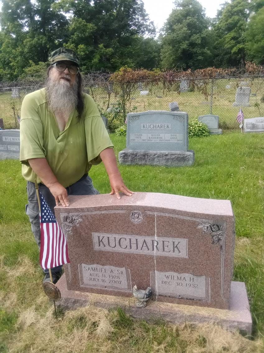 Samuel A. Kucharek by one of his family's gravestones at Slovak Lutheran Cemetery, Johnson City.