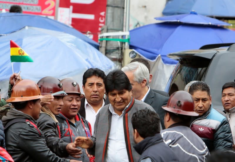 Bolivia's President Evo Morales talks with mine workers after a rally in La Paz