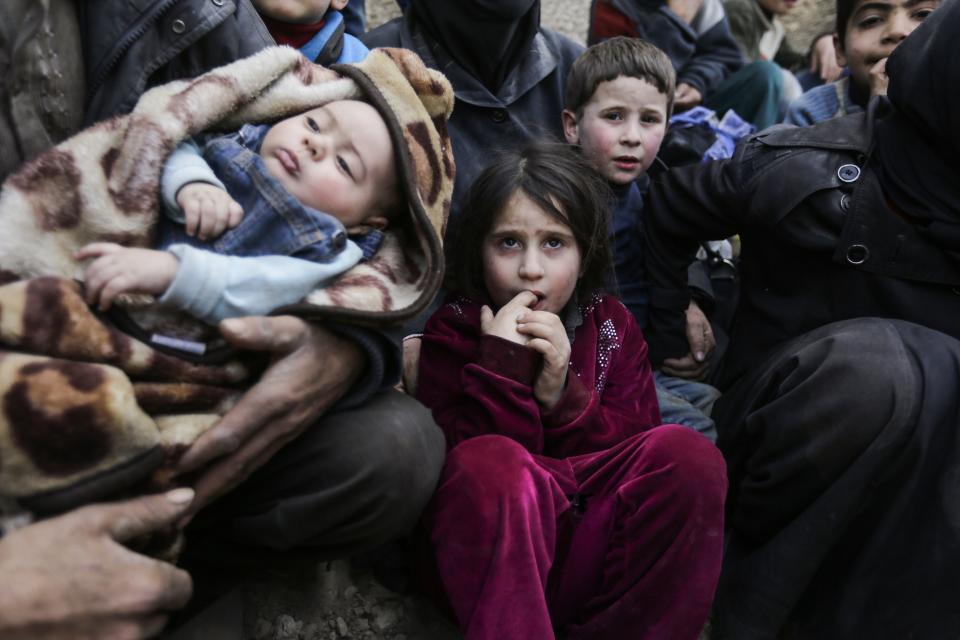 Syrian children wait to be evacuated from the eastern Ghouta enclave on the outskirts of Damascus on March 15, 2018.&nbsp; (Photo: LOUAI BESHARA/Getty Images)